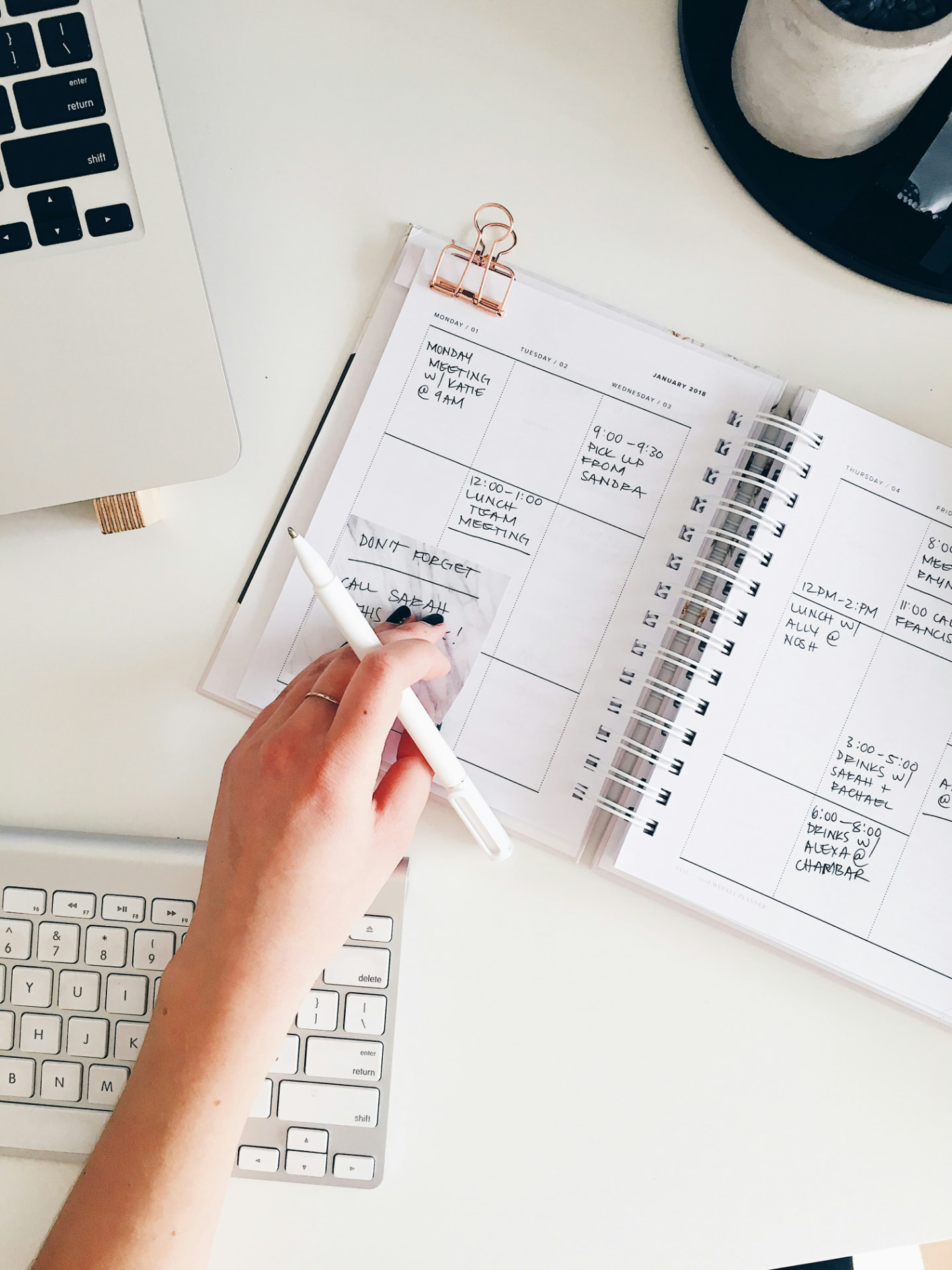 A planner open on a desk with the week written out
